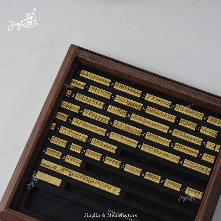 Close-up showing a set of letter stamps neatly organized and aligned within the Letters Stamp Box.